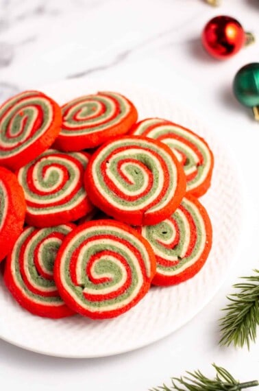 red white and green christmas pinwheel cookies on a plate