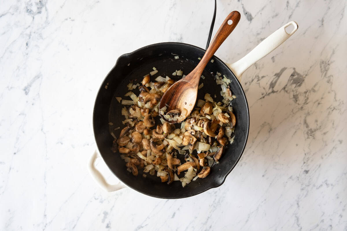 Overhead view of vegetables cooking in skillet