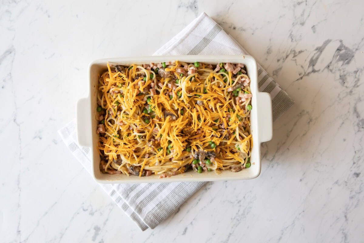 Overhead view of assembled ham tetrazzini in baking dish