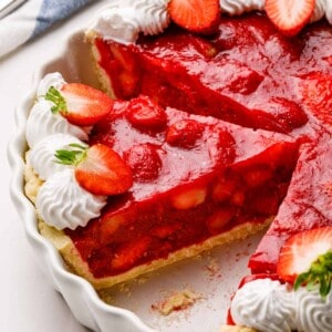 A strawberry pie with a slice missing.