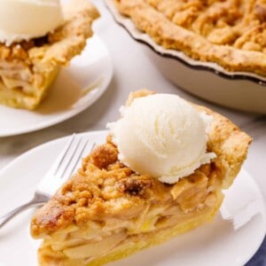 A slice of Dutch apple pie topped with ice cream.
