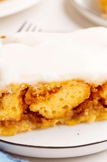 A slice of cinnamon roll cake on a plate.