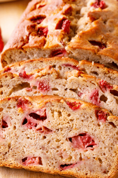 Strawberry banana bread with two slices cut.