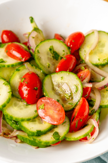 A bowl of cucumber and tomato salad.