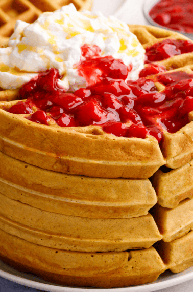 A stack of sourdough waffles on a plate.
