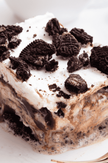 A slice of Oreo ice cream cake on a plate.