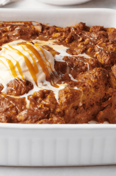 Pumpkin bread pudding topped with vanilla ice cream and caramel sauce.