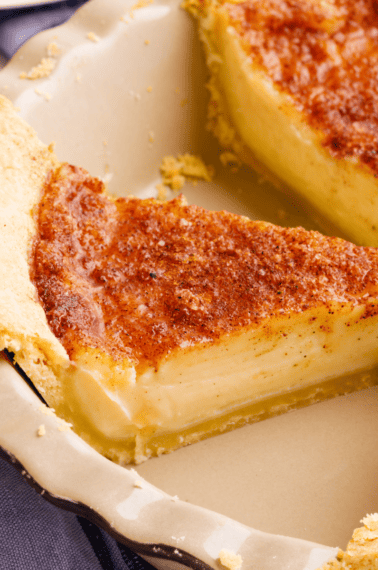 A slice of Amish sugar cream pie in a pie tin.