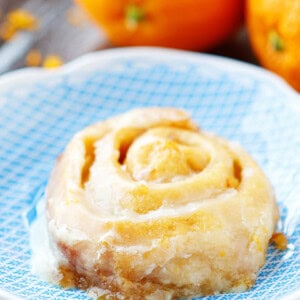 A crock pot orange sweet roll on a plate.