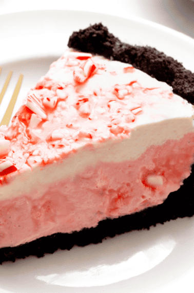 A slice of no bake candy cane pie on a plate.