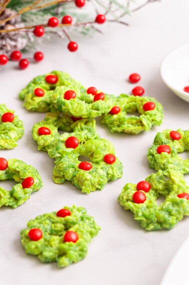Christmas wreath cookies decorated with red candies.