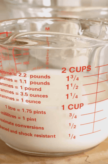A liquid measuring cup of homemade buttermilk.