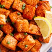 Pan-fried salmon bites on a plate.