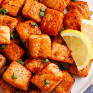 Pan-fried salmon bites on a plate.