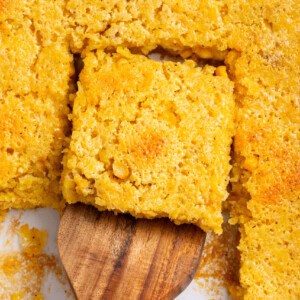 slice of corn souffle with a wooden spatula.