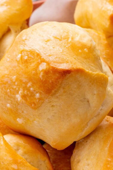 close up of buttered parker house rolls.