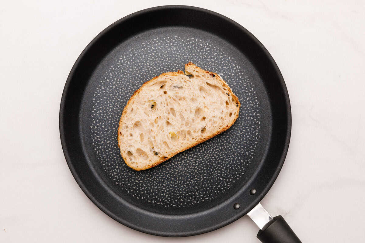 Grilled Cheese Sandwich A slice of bread in a non stick pan.