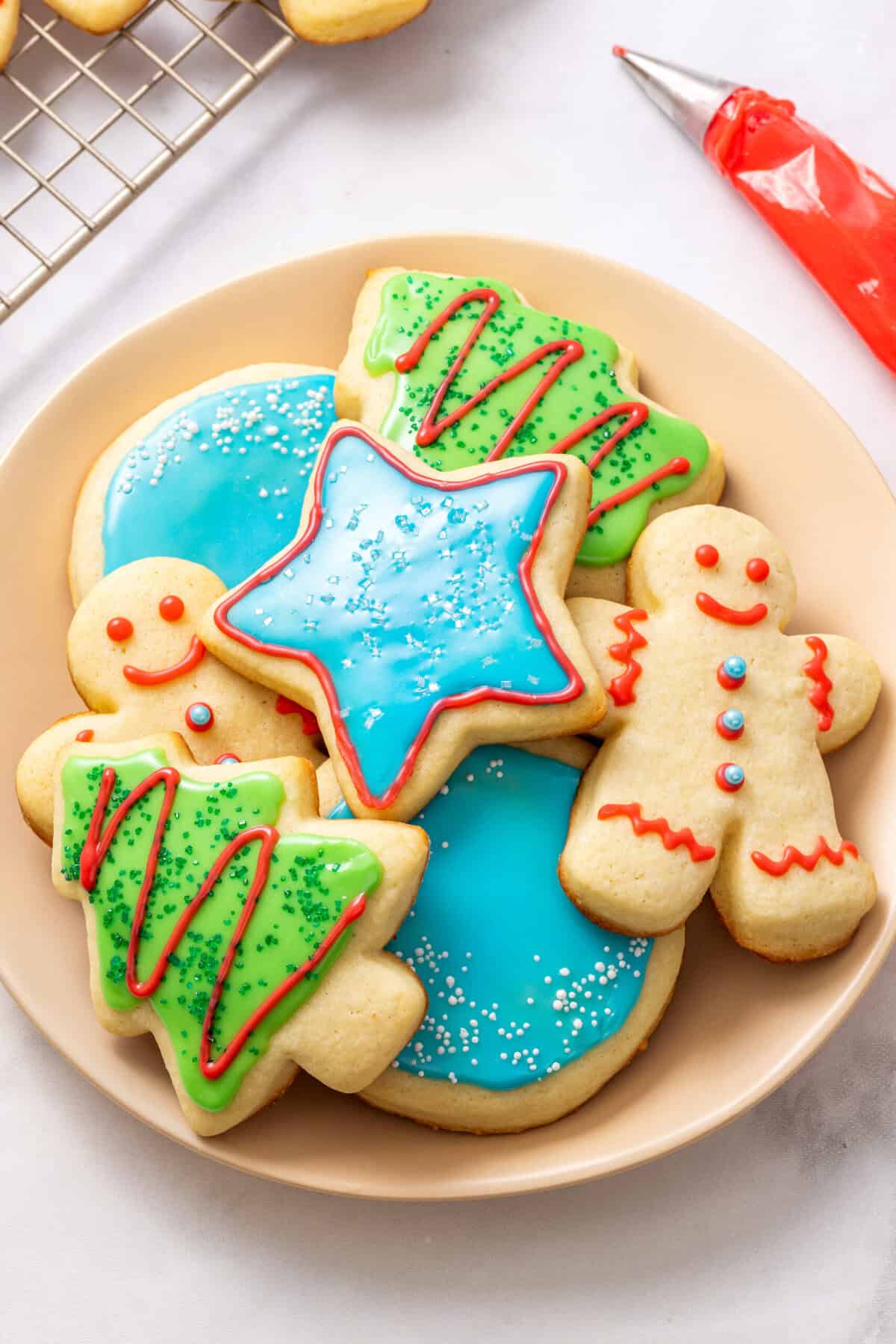 Sugar Cookie Icing A plate of cut out sugar cookies decorated with sugar cookie icing.