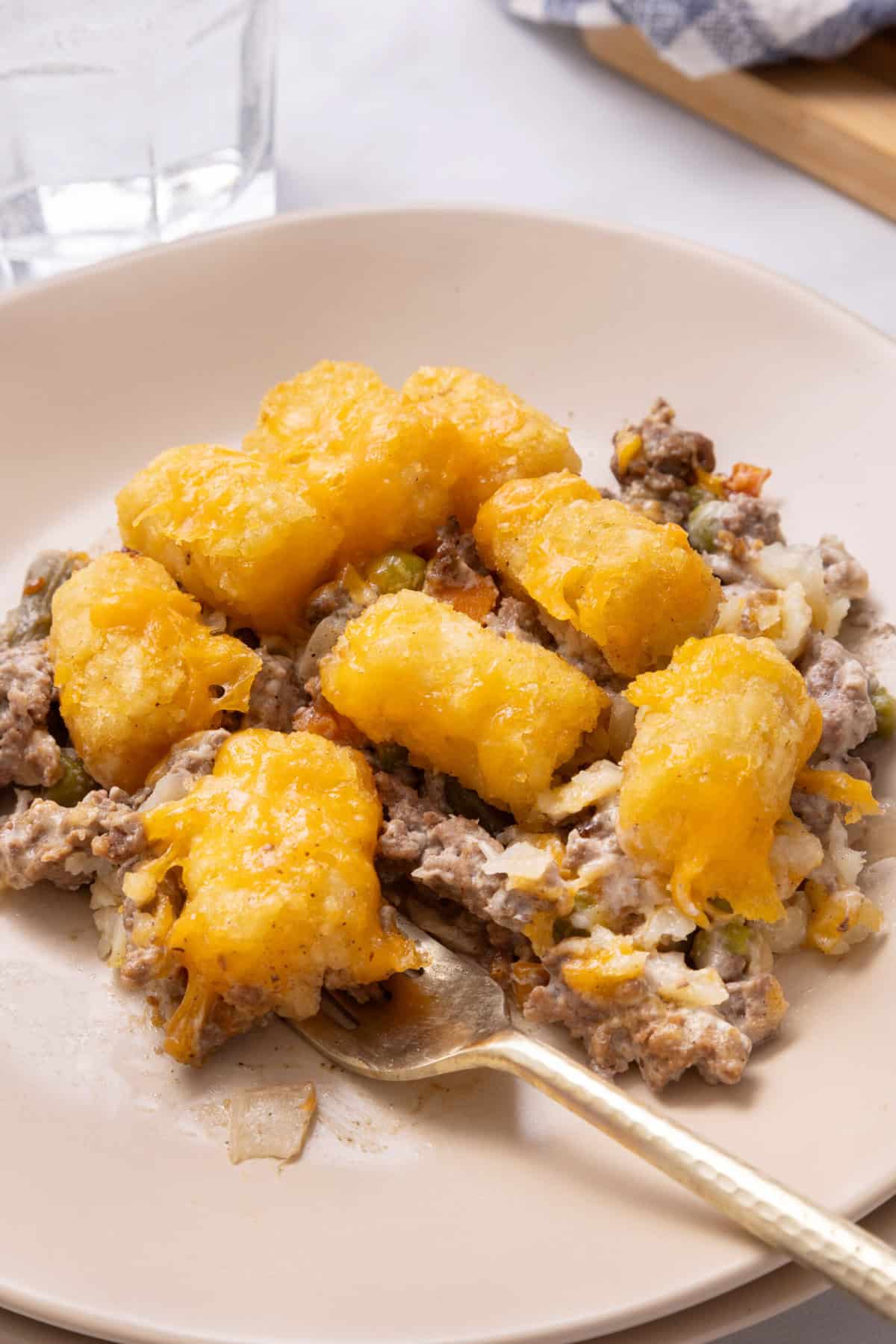 Tater Tot Casserole A serving of Tater Tot Casserole on a white plate.