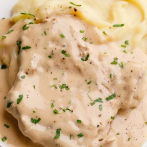 crockpot porkchops with gravy and fresh herbs.