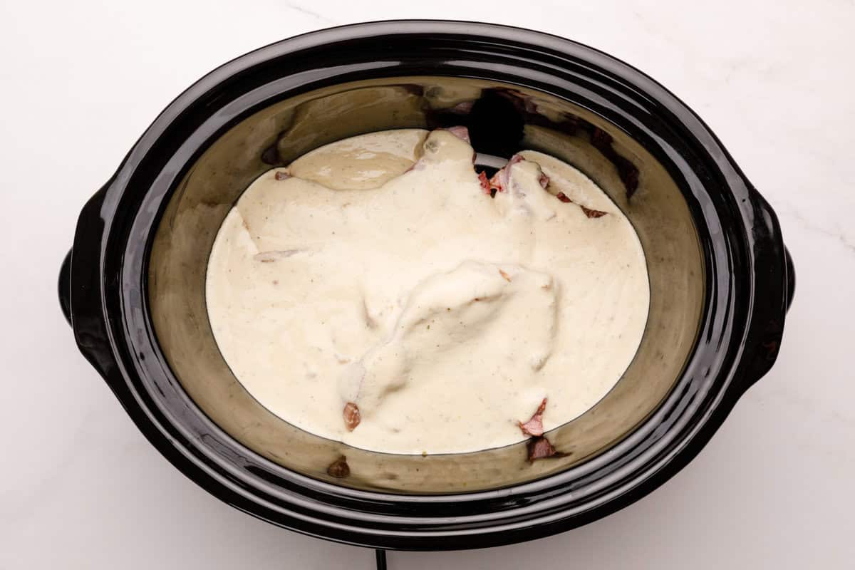 Crockpot pork chops with sauce Sauce and pork in a crockpot.