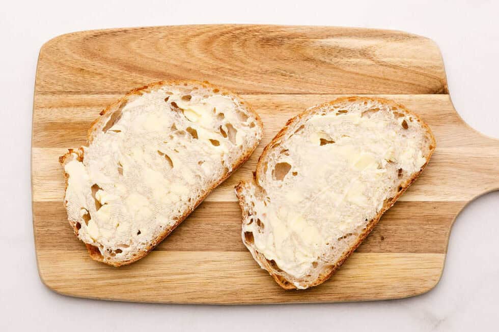 Grilled Cheese Sandwich Two pieces of bread spread with butter.