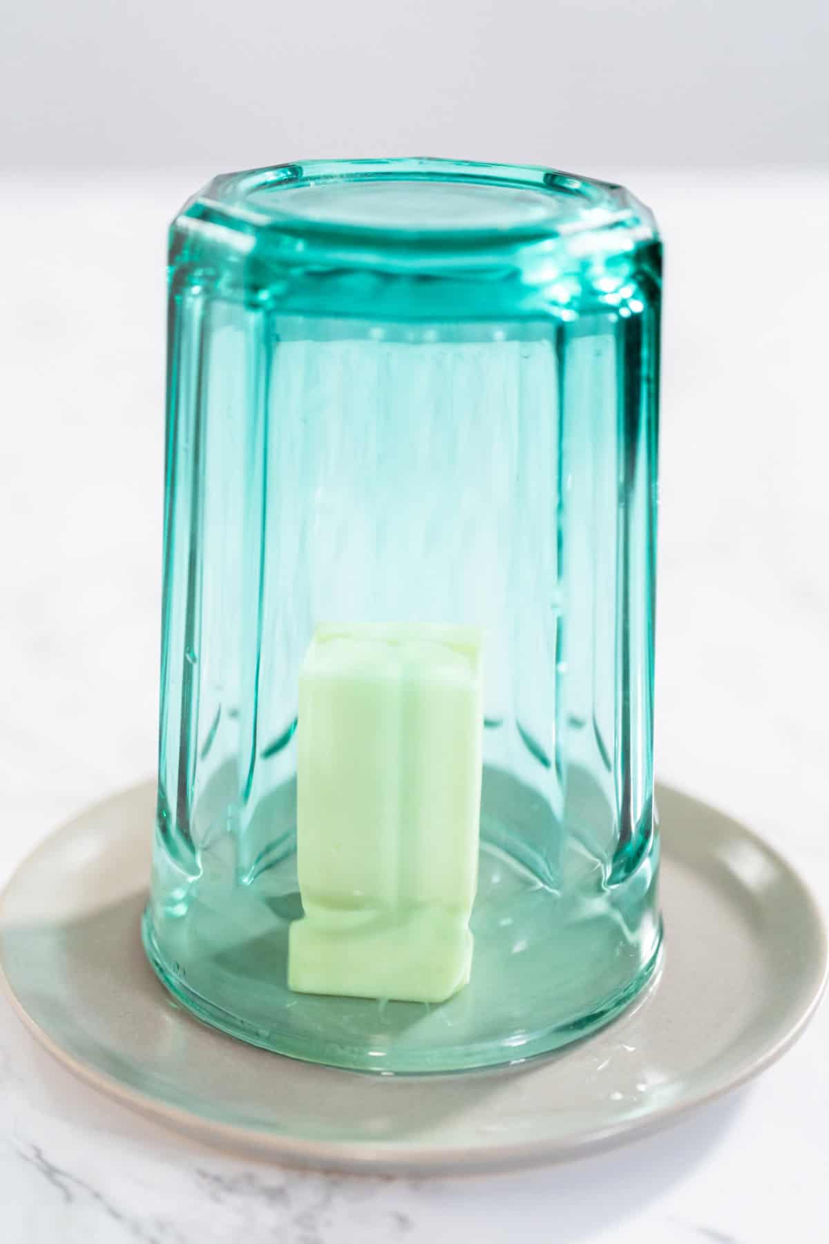 Softening stick of unsalted butter under a hot glass