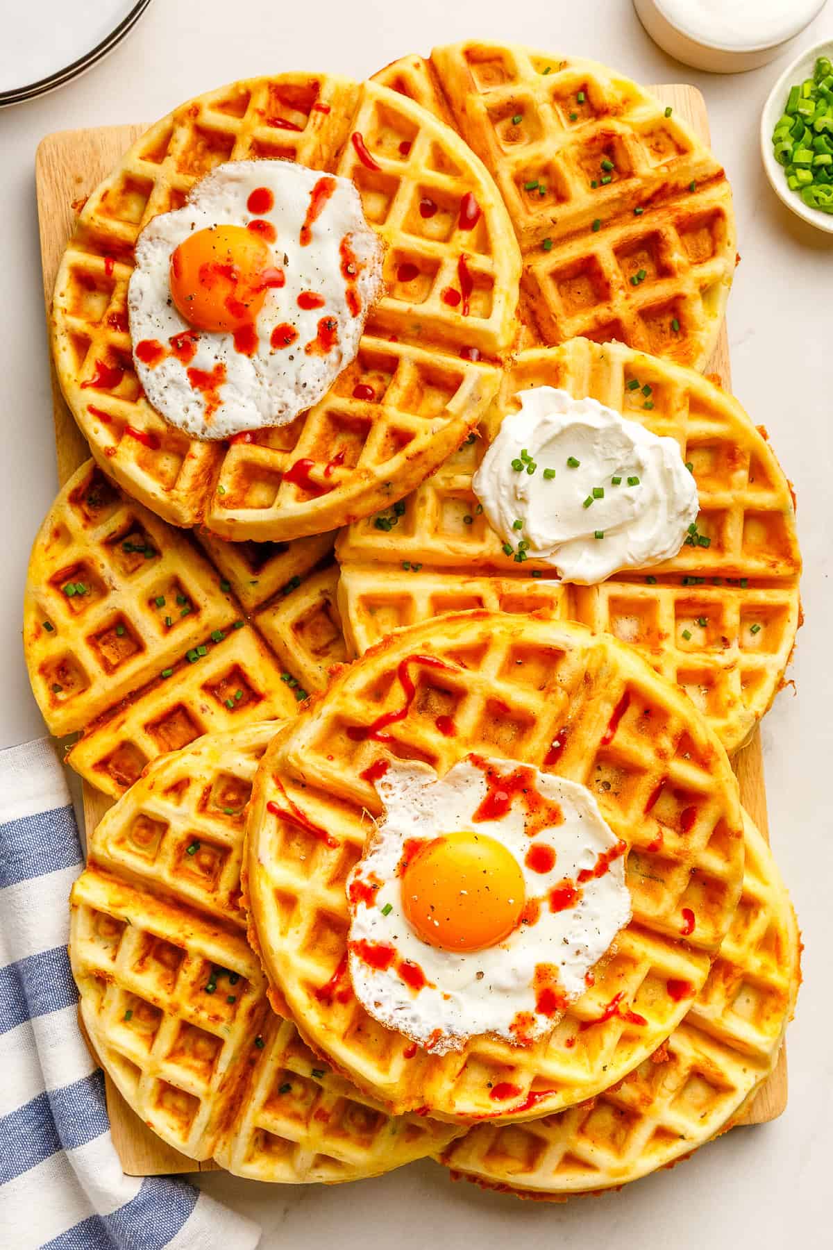 a stack of savory waffles on a cutting board