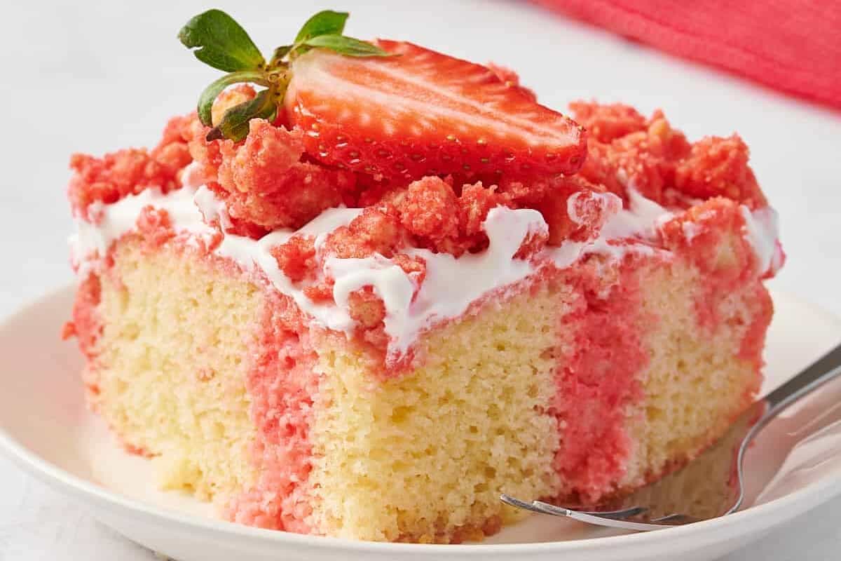 A slice of strawberry crunch poke cake on a plate.