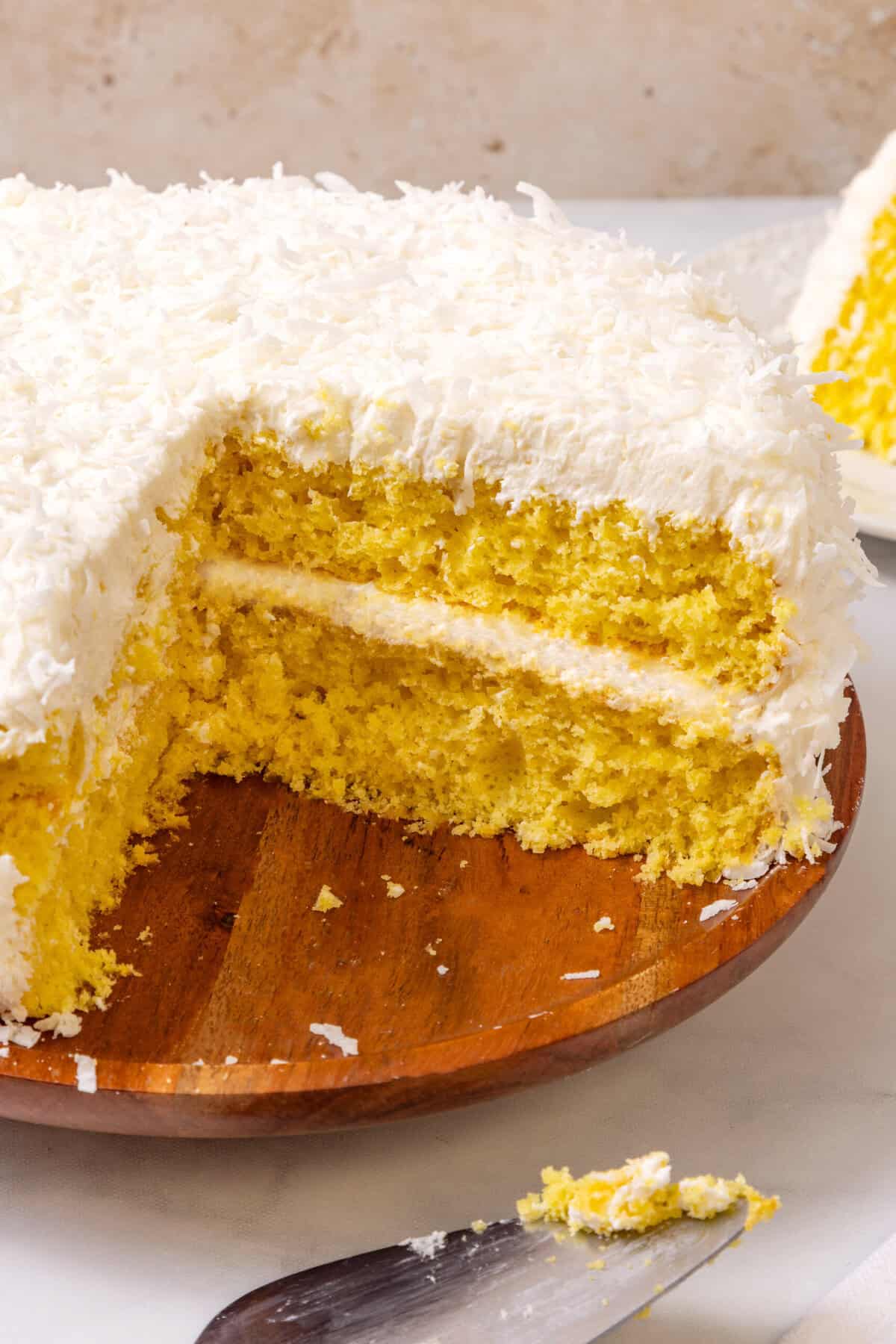 lemon coconut cake lemon coconut layer cake with slice cut out.