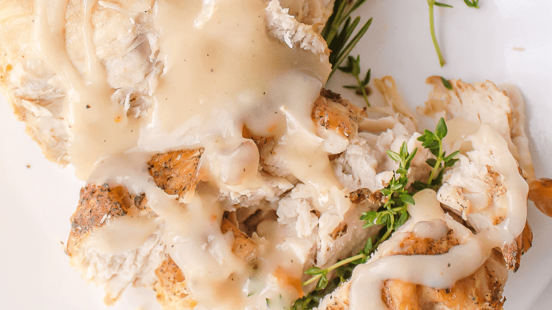 crockpot turkey breast with homemade gravy served on a plate