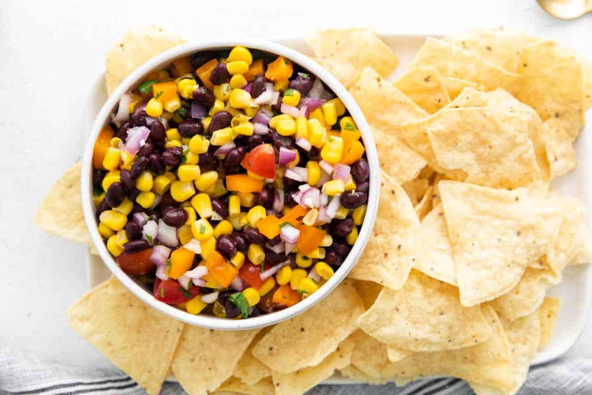 Overhead shot of Black Bean and Corn Salsa in bowl with tortilla chips.