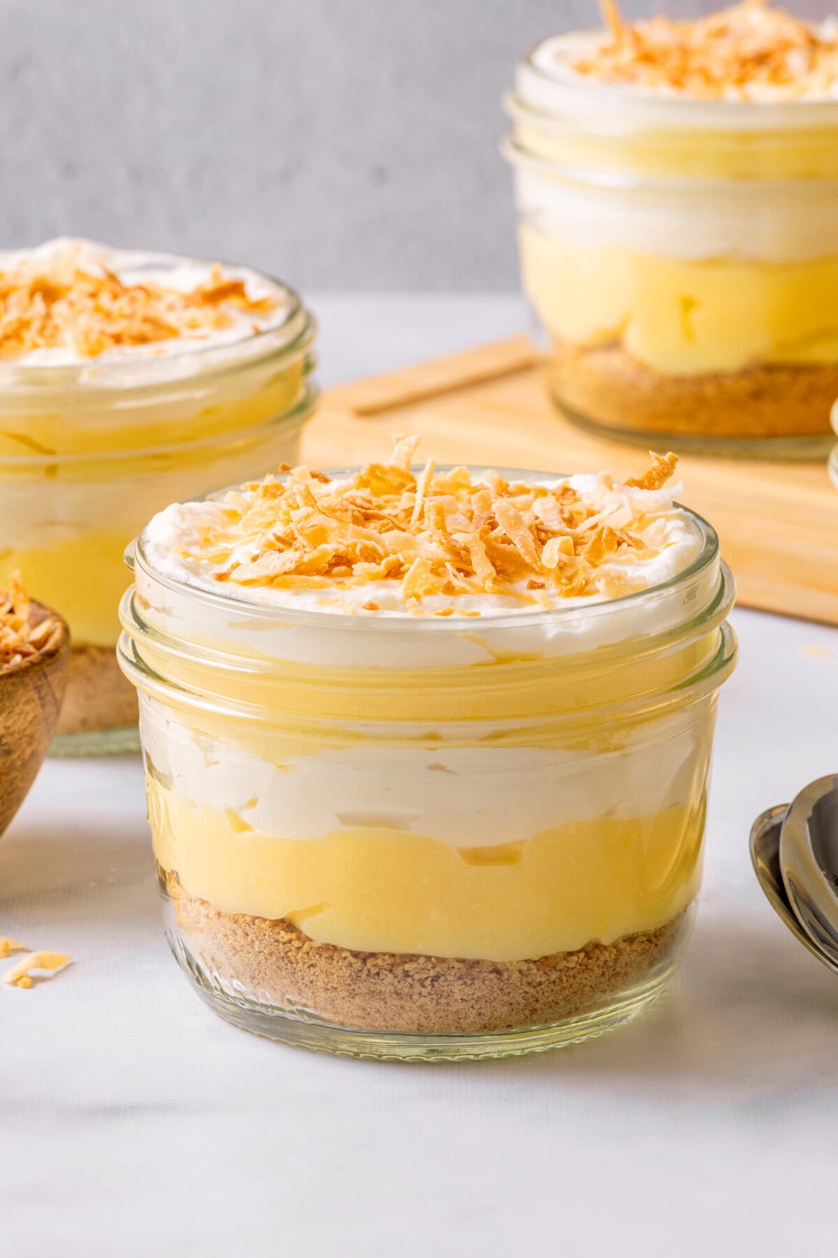 3 coconut cream pie parfaits in glass jars