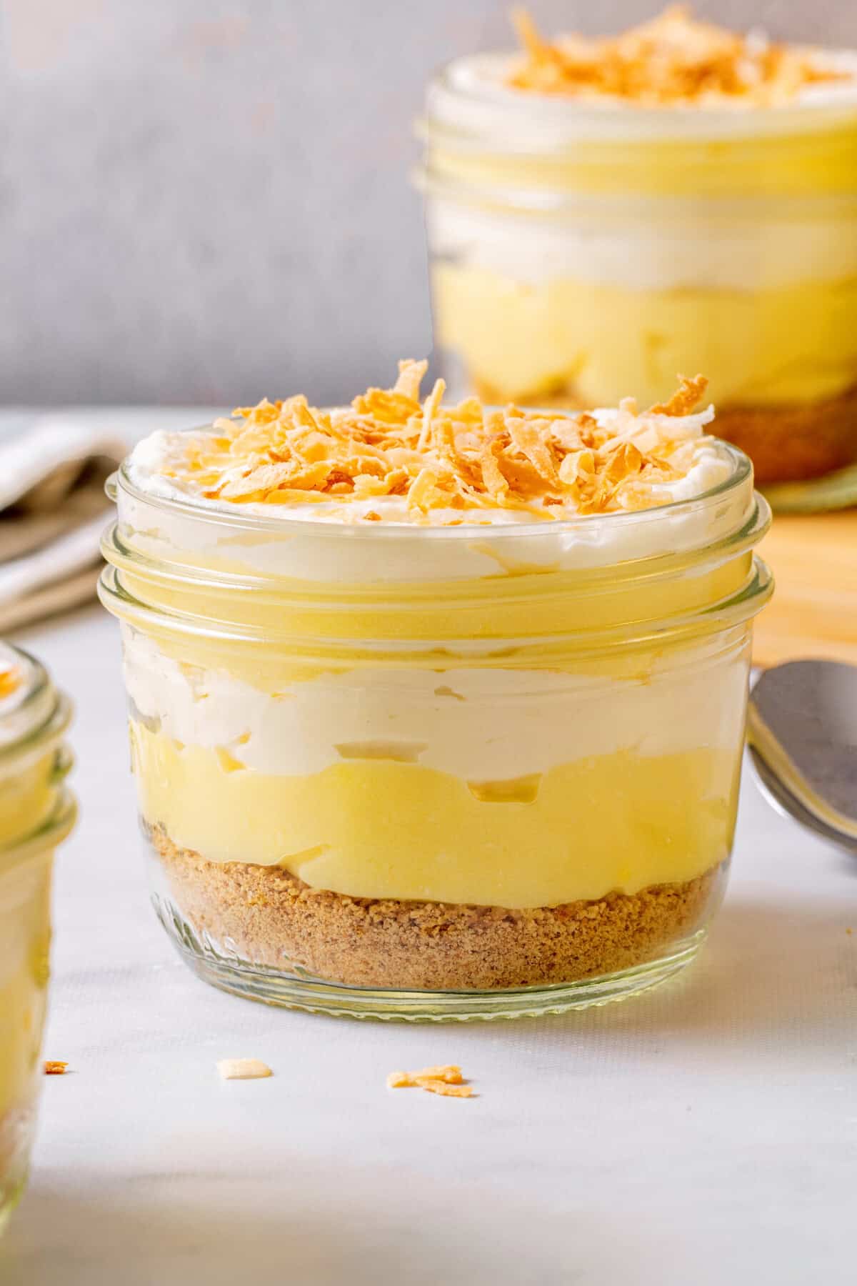 Coconut cream parfait in mason jar with toasted coconut on top