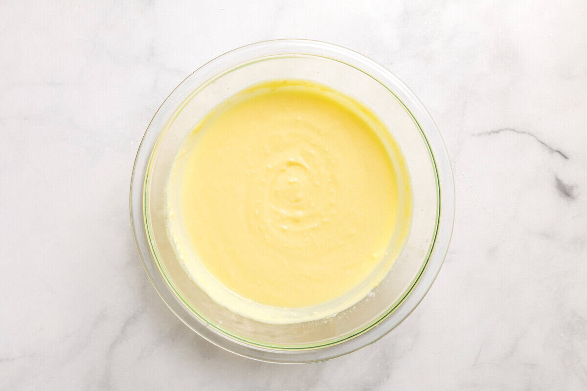 Overhead view of coconut pudding in glass mixing bowl